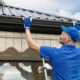 a man installing roof rain gutter 80x80